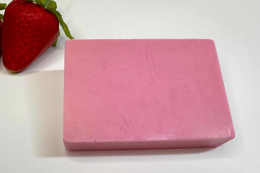 DIY Soap Making Refill Kit with a solid pink rectangular soap bar and a red strawberry beside it