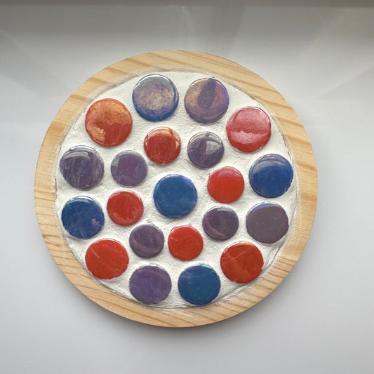 Orange, blue and purple round mosaic tiles in coaster. 