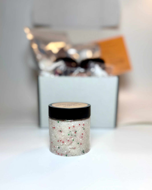 Christmas Sugar Cookie Sugar Scrub in a clear jar, showing creamy white scrub with red and green festive sprinkles