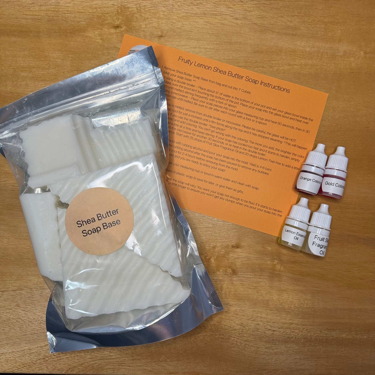 DIY Soap Making Refill Kit with white shea butter soap base, small bottles of fragrance and color, and instructions