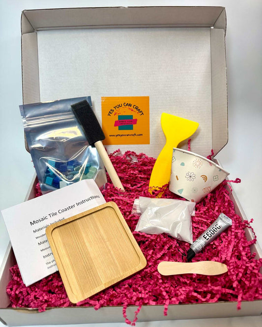 Mosaic Tile Coaster crafting kit with a natural bamboo coaster, grout, glue, mosaic tiles and colorful tools in a box.