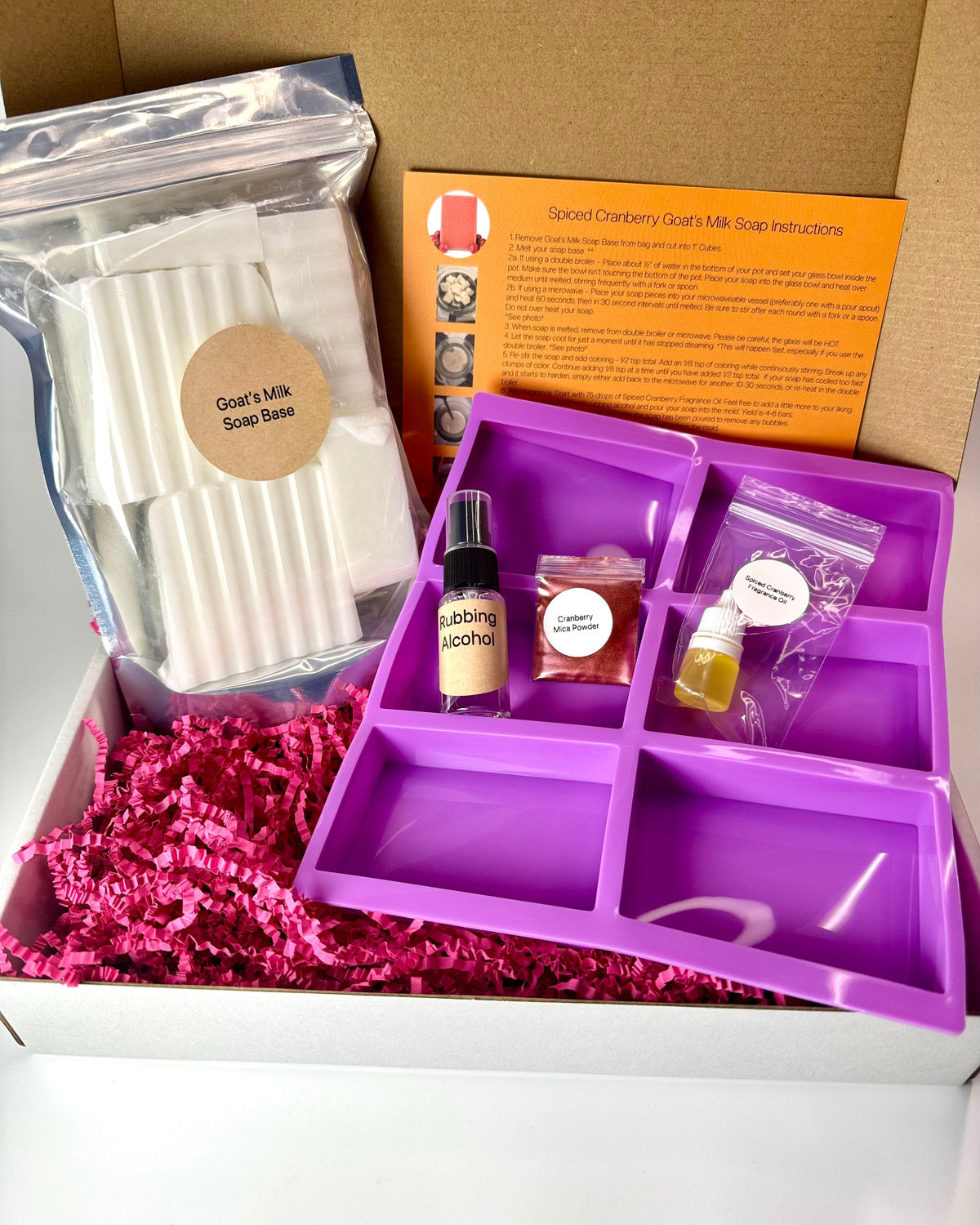 Spiced Cranberry soap making kit contents including soap base, soap mold, fragrance, coloring, rubbing alcohol and instructions.
